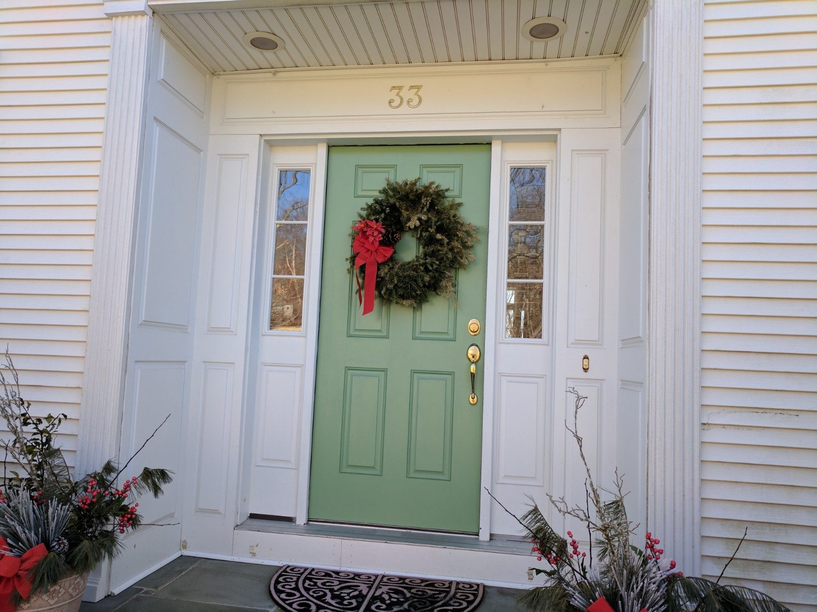 Entrance with inset door to provide shelter from rain, side lights to let light into hall